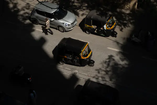 Two autos and a tree's shadow